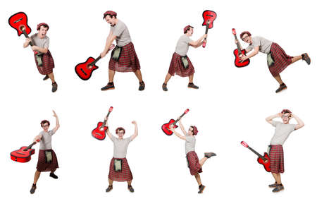 Scotsman playing guitar isolated on whiteの写真素材