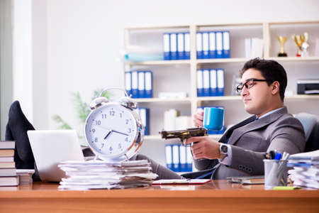Young businessman in time management conceptの写真素材