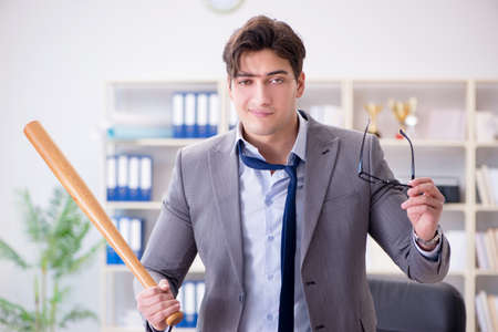 Angry aggressive businessman in the officeの写真素材