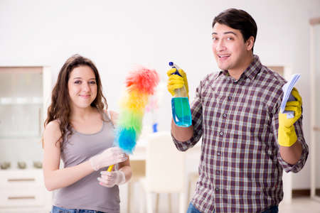 Wife and husband doing cleaning at home