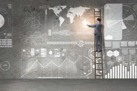 Businessman climbing ladder in global business conceptの写真素材