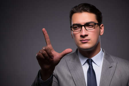 Handsome businessman pressing virtual buttonsの写真素材