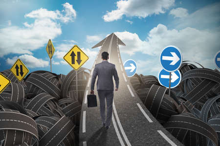 Businessman in uncertainty concept on road intersection crossroaの写真素材