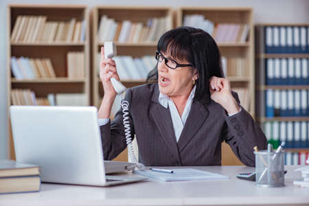 Mature businesswoman working in the officeの写真素材