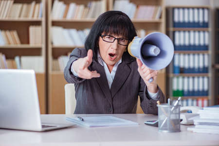 Mature businesswoman working in the officeの写真素材