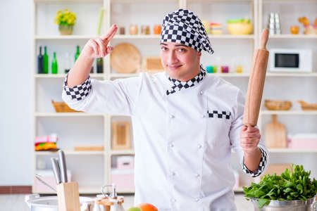 Young male cook working in the kitchen