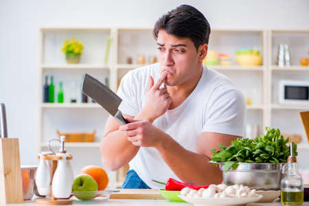 Young male cook working in the kitchenの写真素材