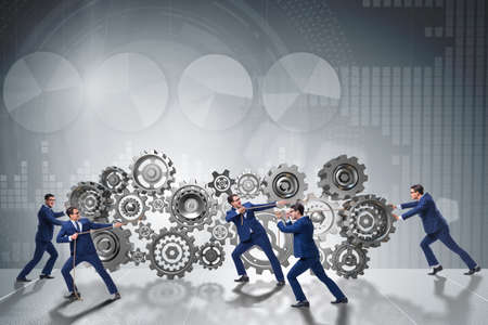 Businessman in teamwork concept with cogwheelsの写真素材