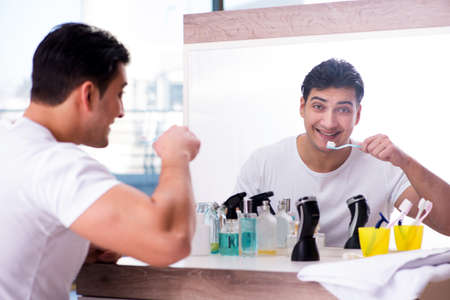 Handsome man brushing teeth in the morningの写真素材