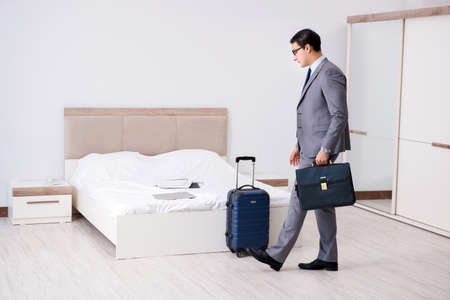 Businessman working in hotel roomの写真素材
