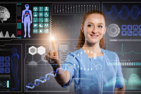 Doctor in futuristic medical concept pressing buttonの写真素材