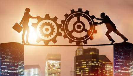 Businesspeople in teamwork example with cogwheelsの写真素材