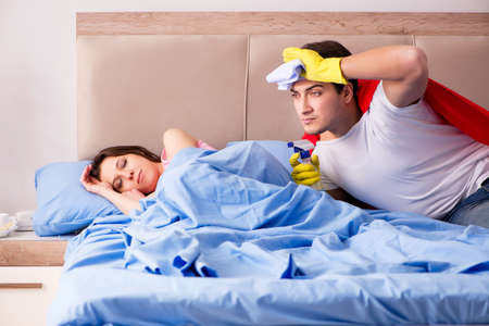 Super hero husband in bedの写真素材