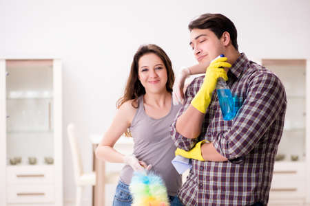 Wife and husband doing cleaning at homeの写真素材
