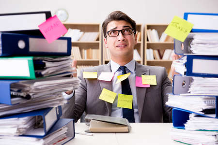 Businessman struggling with multiple prioritiesの写真素材