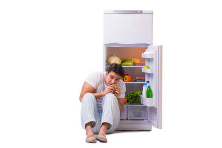 Man next to fridge full of foodの写真素材