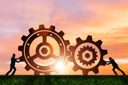 Businessman in teamwork concept with cogwheelsの写真素材