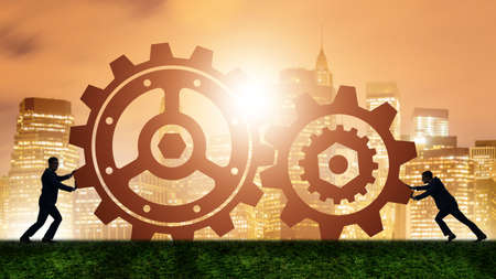 Businessman in teamwork concept with cogwheels