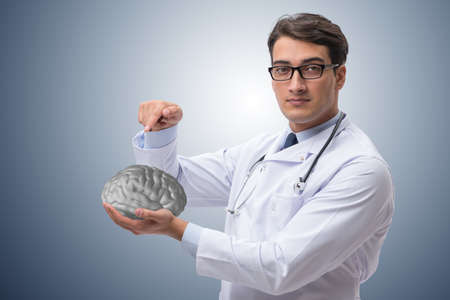 Male doctor with the brain in medical conceptの写真素材