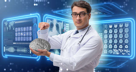 Male doctor with the brain in medical concept