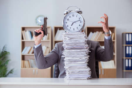 Businessman busy with paperwork in officeの写真素材