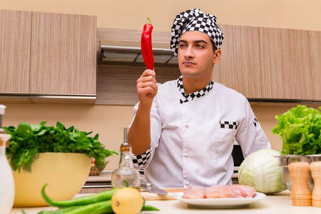 Young chef working in the kitchenの写真素材