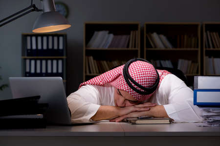 Arab businessman working late in officeの写真素材