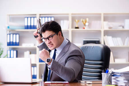 Angry aggressive businessman in the officeの写真素材