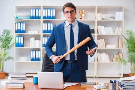 Angry aggressive businessman in the officeの写真素材
