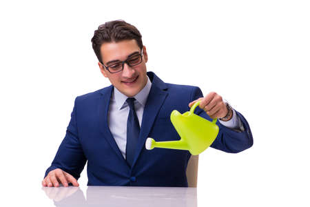 Businessman with watering can isolated on whiteの写真素材