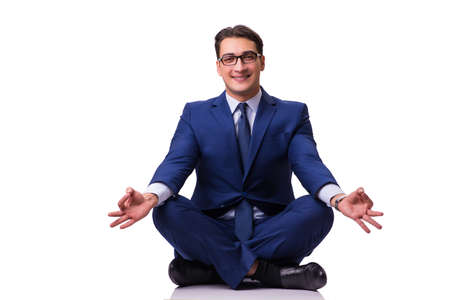 Businessman meditating on the floor isolated on whiteの写真素材