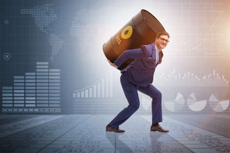 Businessman under the burden of oil barrelの写真素材