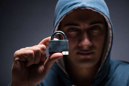 Computer hacker working in dark roomの写真素材