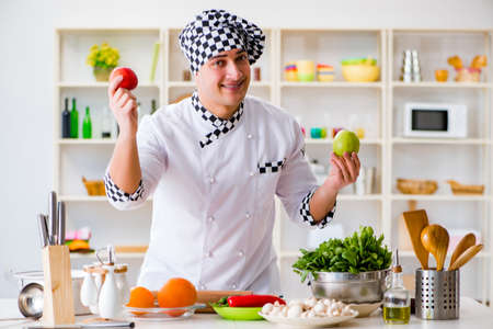 Young male cook working in the kitchenの写真素材