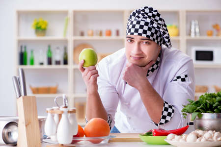 Young male cook working in the kitchenの写真素材