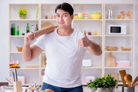Young male cook working in the kitchenの写真素材