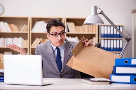 Businessman receiving parcel in the officeの写真素材