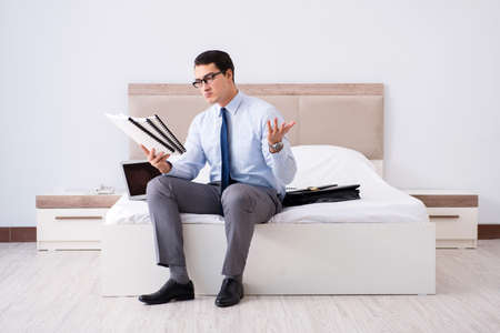 Businessman working in hotel roomの写真素材