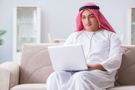 Arab businessman working sitting at couchの写真素材