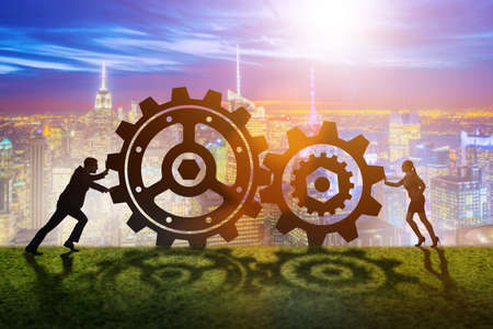 Businesspeople in teamwork example with cogwheelsの写真素材