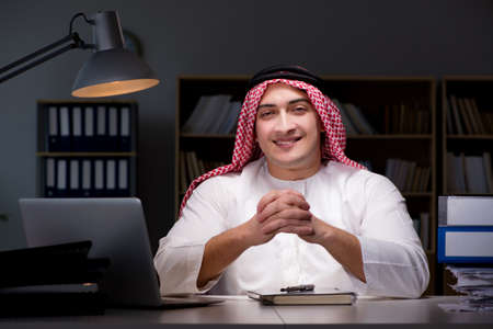 Arab businessman working late in officeの写真素材