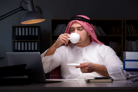 Arab businessman working late in officeの写真素材