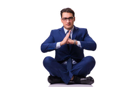 Businessman sitting on the floor isolated on whiteの写真素材