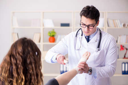 Traumatologist is taking care of the patientの写真素材