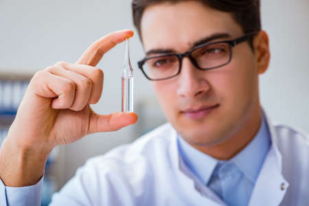 Doctor holding medicines in the labの写真素材