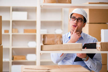 Man working in postal parcel delivery service officeの写真素材
