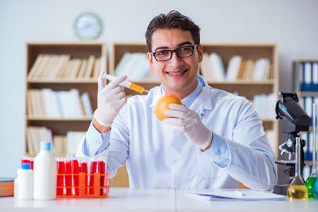 Scientist working on organic fruits and vegetablesの写真素材