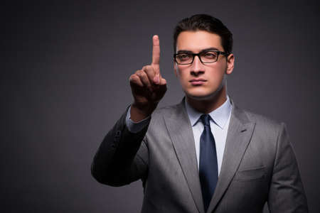 Handsome businessman pressing virtual buttonsの写真素材
