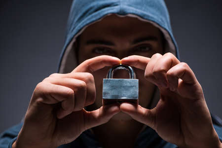 Computer hacker working in dark roomの写真素材