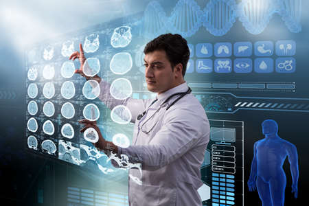 Male doctor studing x-ray image of MRI scanの写真素材